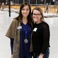 Two alumnae pose for a photo together at the Fowling Fun Event
